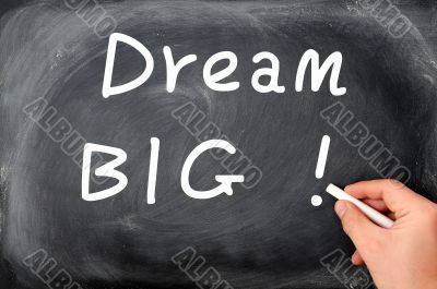 Dream big written with chalk on a blackboard background