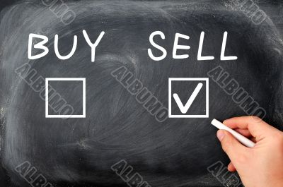 Buy or sell check boxes written on a blackboard