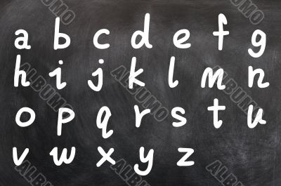 English alphabet handwritten with white chalk on a blackboard