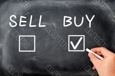 Buy or sell check boxes written on a blackboard