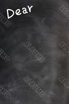 Title of Dear written with chalk on a blackboard 