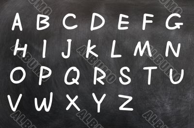 English alphabet handwritten with white chalk on a blackboard