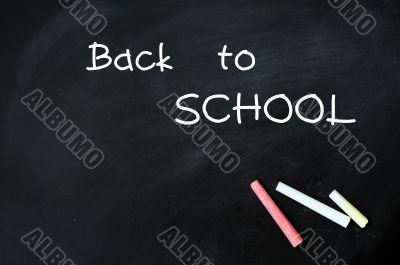 Back to school - text on a blackboard with chalk