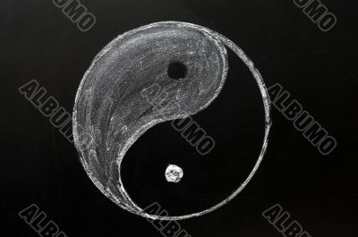 Tai Chi or yingyang symbol drawn in chalk on a blackboard 
