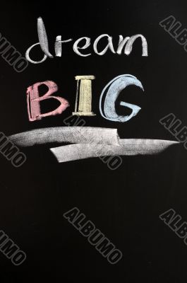 Dream big text written on a blackboard