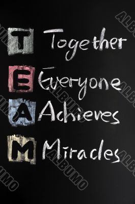 TEAM acronym written in colorful chalk