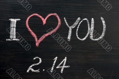 Love with valentine `s date drawn on a chalkboard