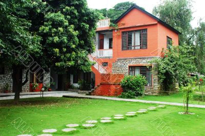 Red house with green meadows