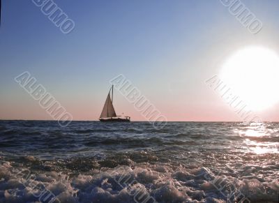 Lonely sail drifting by the sea summertime Lonely sail drifting by the sea summertime