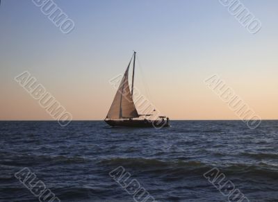 Lonely sail drifting by the sea summertime