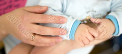 close up of baby in mother`s hands