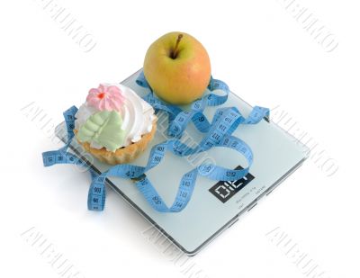 Cake and apple on scales measuring tape wrapped
