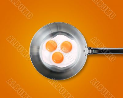 Three Fried eggs in a frying pan 