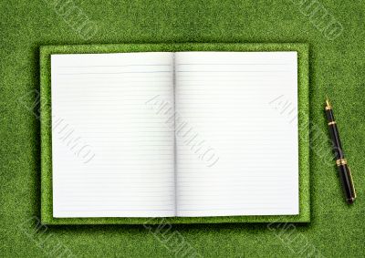 Blank book on grass