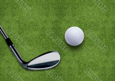 Golf ball and putter on green grass 