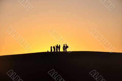 Silhouette of travelers at sunset