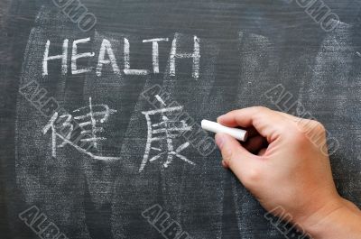 Health - word written on a blackboard with a Chinese version