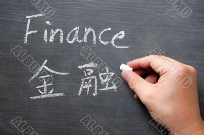 Finance - word written on a smudged blackboard