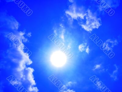 Blue sky with clouds and sun