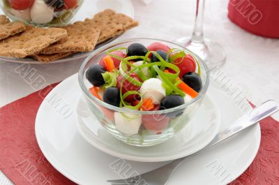 Salad of lettuce, cherry tomatoes, olives and mozzarella with pe