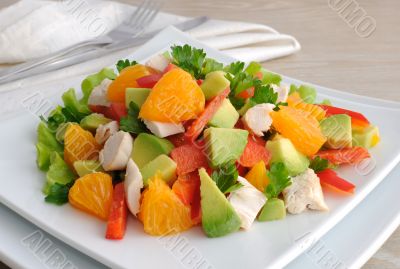 Chicken salad with avocado, sweet pepper and orange