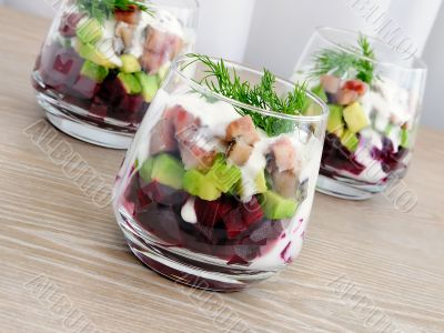 Appetizer in a glass of beet and herring with avocado