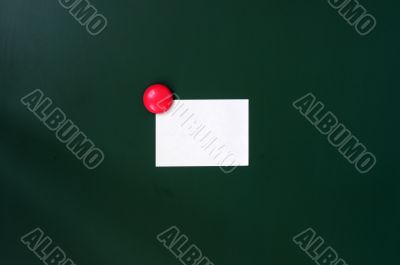 Blank stick note on a green board