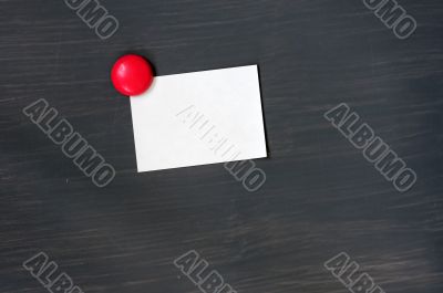 Blank stick note on a blackboard