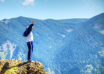 Man staying at the edge of the rock