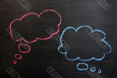 Chalk drawing of blank think bubbles on a blackboard background