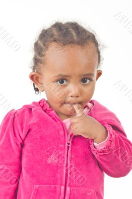 Playful little girl with a finger in her mouth