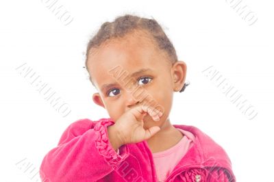 Playful little girl with a finger in her mouth