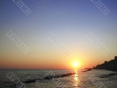 Round sun falling down over the Black sea