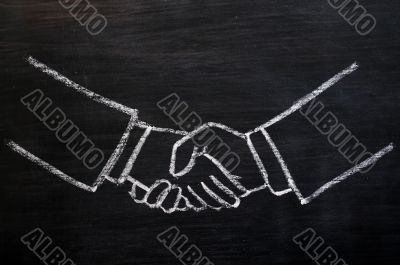 Chalk drawing of handshaking on a blackboard