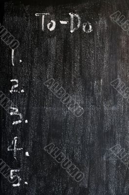 Blank to-do list on a smudged blackboard