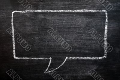 Blank speech bubble drawn on a smudged blackboard