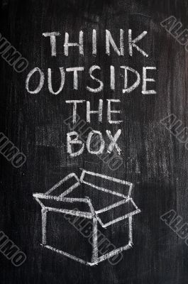 Concept of `Think Outside the box` drawn with chalk on a blackboard 
