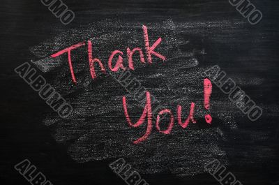 Thank you written with red chalk on a smudged blackboard