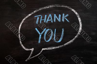 Thank you written with blue chalk on a smudged blackboard