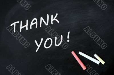 Thank you written with chalk on a smudged blackboard