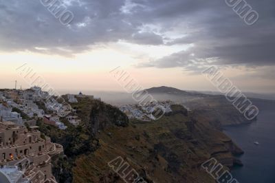 Early morning fog above Santorini and sunrise