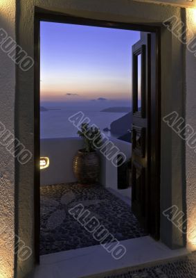 Santorini Caldera twilight view trough the open door