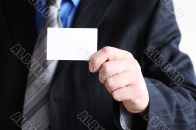 Successful businessman holding empty card 
