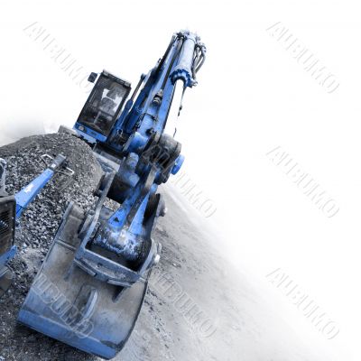backhoe digging small stones
