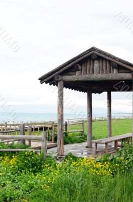Wooden pavilion and fence in the grassland