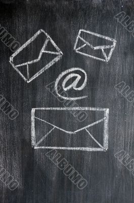 Chalk drawing of email symbols on a blackboard 