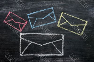 Chalk drawing of email symbols on a blackboard 