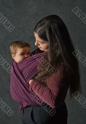Mother with her daughter in sling Mother with her daughter in sling
