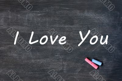 I love you - written with chalk on a Smudged blackboard background I love you - written with chalk on a Smudged blackboard background