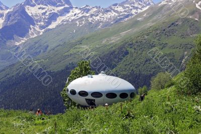 People around UFO that landing between caucasus mountains